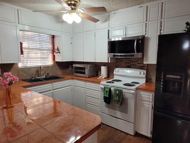 kitchen with sink, white cabinetry, butcher block counters, white electric range oven, and black refrigerator with ice dispenser