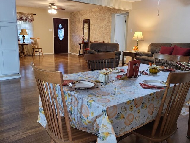 dining space with dark hardwood / wood-style floors and ceiling fan