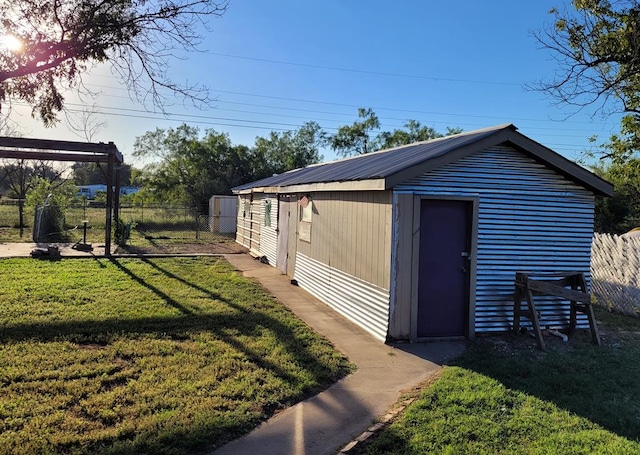 view of outbuilding featuring a yard