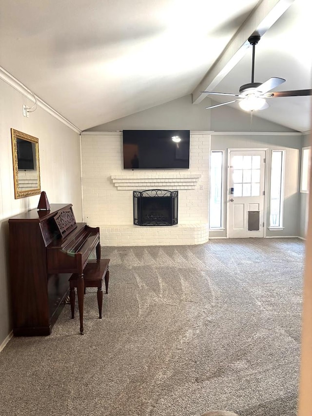 living room with carpet, vaulted ceiling with beams, ceiling fan, and a brick fireplace