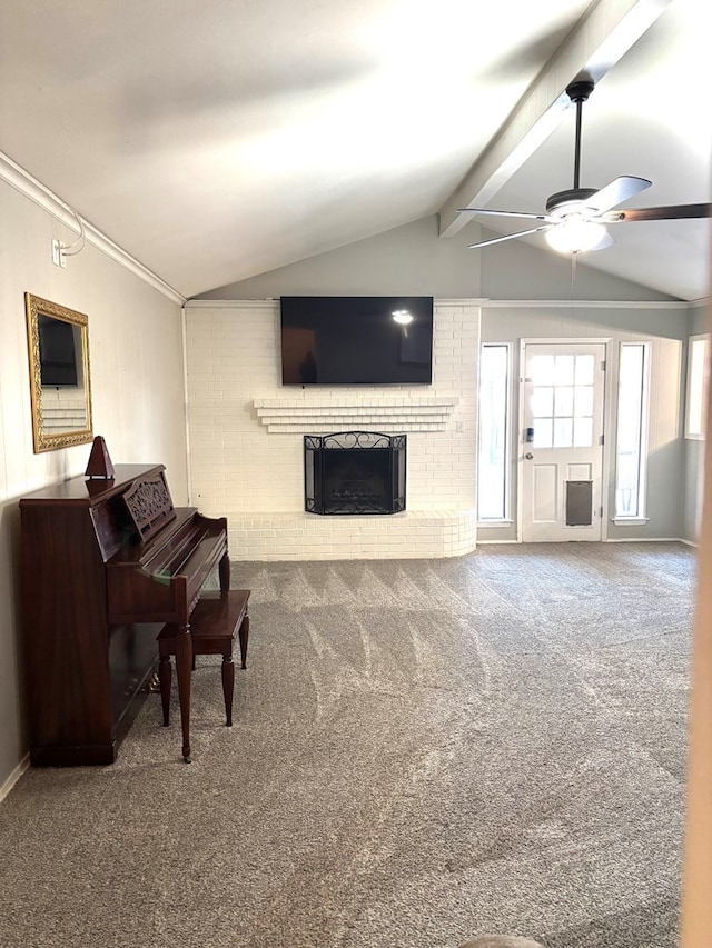 carpeted living room with a fireplace, lofted ceiling with beams, and ceiling fan