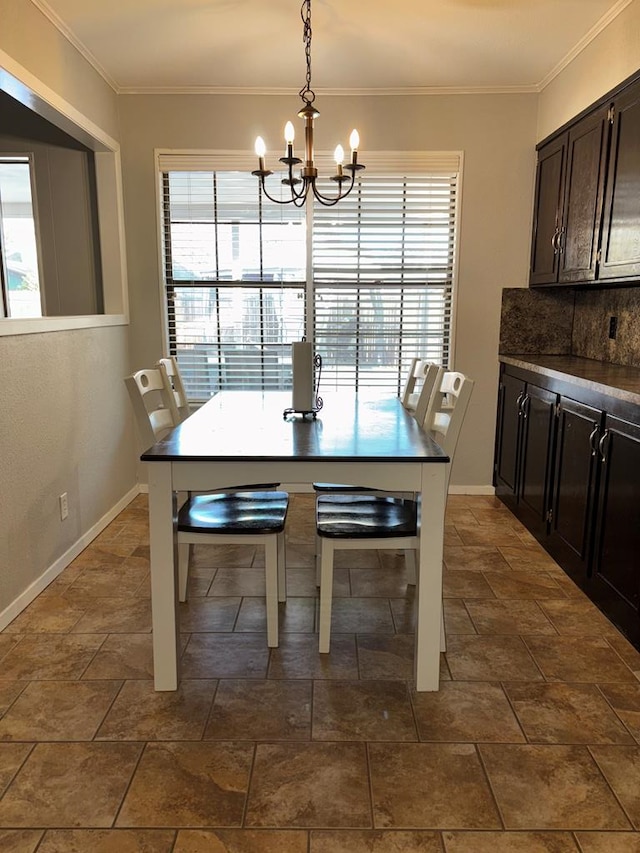 dining room featuring ornamental molding and a notable chandelier