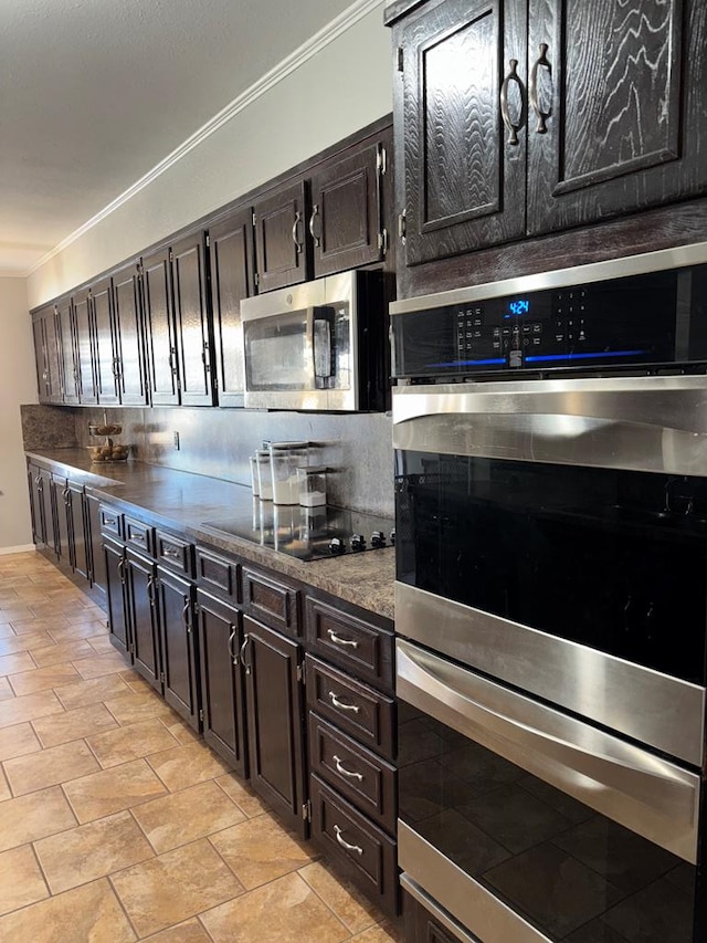 kitchen featuring stainless steel appliances, crown molding, dark brown cabinetry, and decorative backsplash