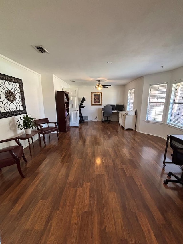 unfurnished living room with ceiling fan and dark hardwood / wood-style flooring