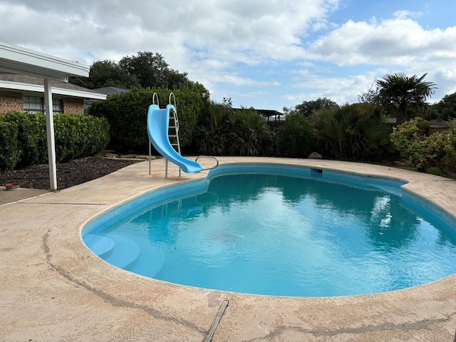 view of pool with a water slide