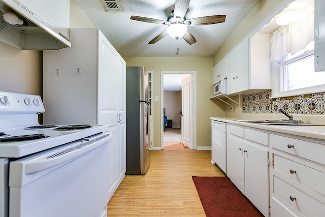 kitchen featuring sink, white appliances, ceiling fan, light hardwood / wood-style floors, and white cabinets