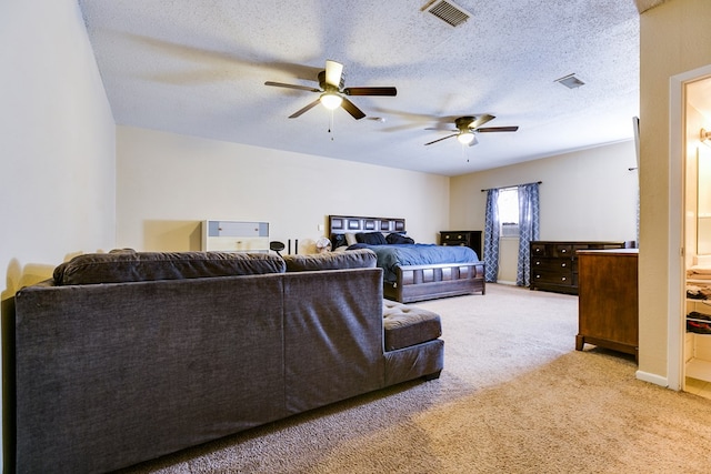 carpeted bedroom with a textured ceiling and ceiling fan