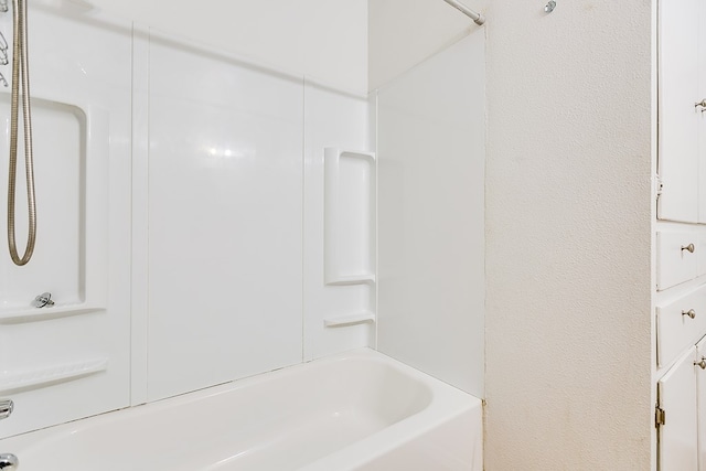 bathroom with shower / washtub combination