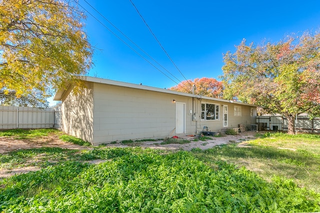 rear view of property featuring a yard