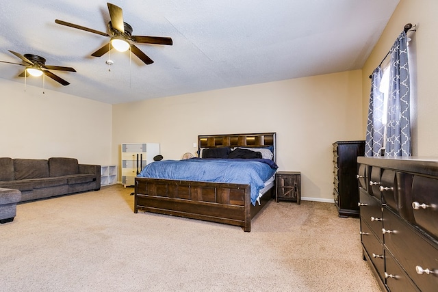 carpeted bedroom with a textured ceiling and ceiling fan