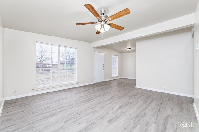 unfurnished living room with ceiling fan and light hardwood / wood-style flooring