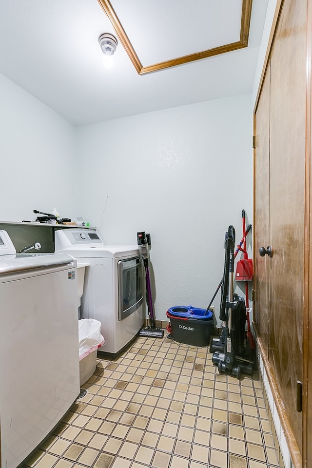 washroom featuring laundry area, separate washer and dryer, and visible vents