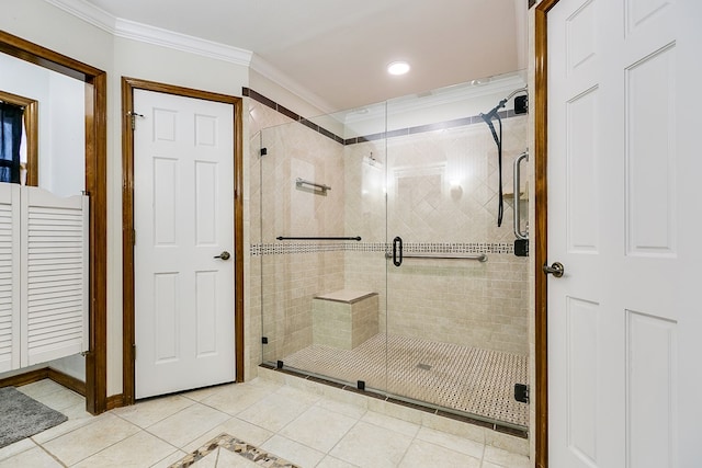 bathroom featuring a stall shower, ornamental molding, and tile patterned floors