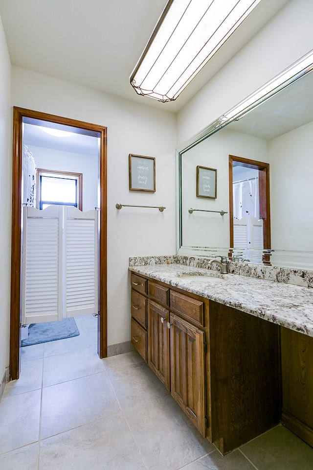 bathroom featuring vanity and baseboards