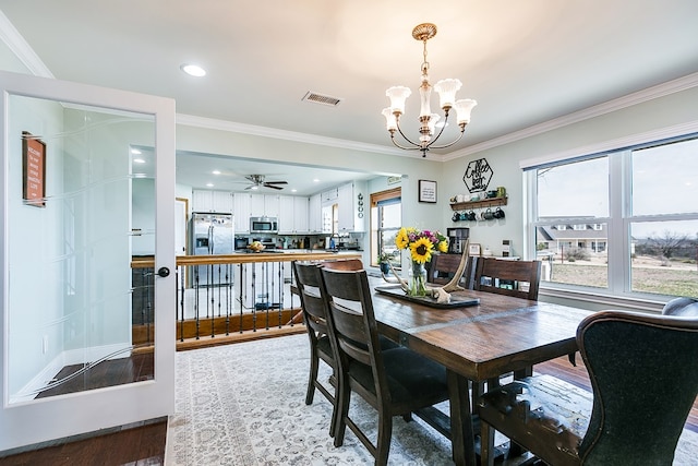 dining space featuring recessed lighting, wood finished floors, visible vents, and ornamental molding