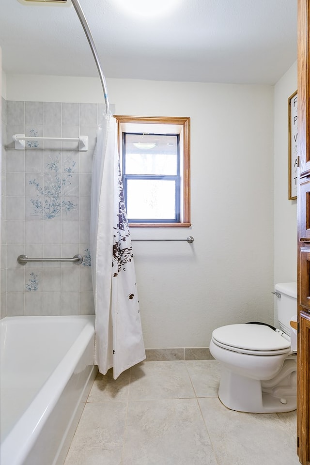 full bathroom with tile patterned floors, shower / tub combo, toilet, and baseboards