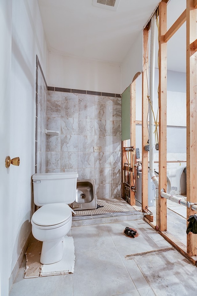 bathroom with visible vents, toilet, and a walk in shower