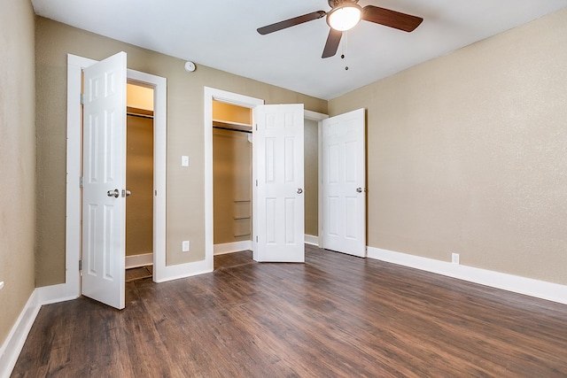 unfurnished bedroom with ceiling fan, baseboards, and dark wood-type flooring