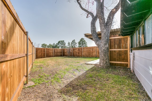 view of yard with a fenced backyard