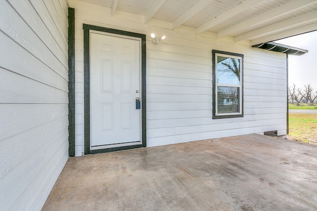 view of exterior entry featuring a patio