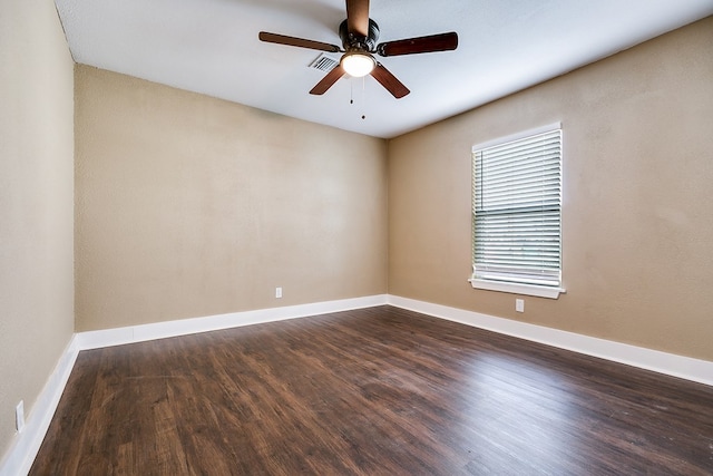 unfurnished room with ceiling fan, baseboards, and dark wood finished floors