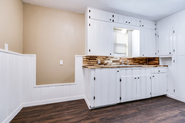 kitchen featuring light countertops, white cabinets, and dark wood finished floors