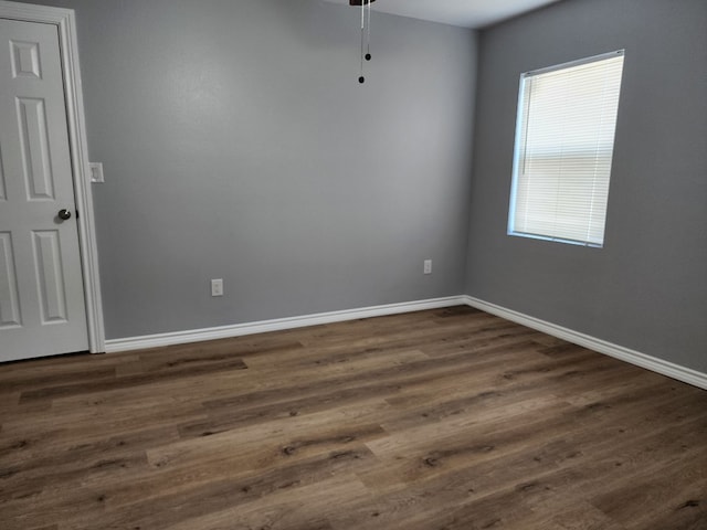 empty room featuring dark hardwood / wood-style flooring