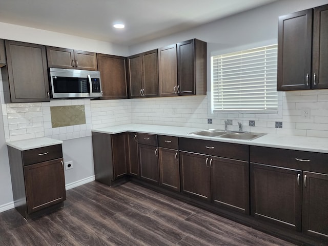 kitchen with dark brown cabinetry, sink, and dark hardwood / wood-style flooring