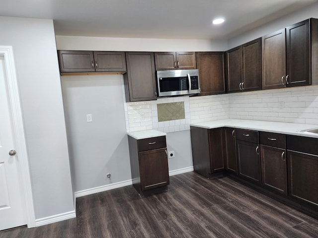 kitchen with tasteful backsplash, dark hardwood / wood-style flooring, and dark brown cabinetry