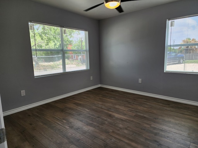 spare room featuring dark wood-type flooring and ceiling fan