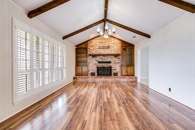 4302 Homestead Cir, Wall, TX 76903 - unfurnished living room with a chandelier, wood finished floors, a brick fireplace, and built in features