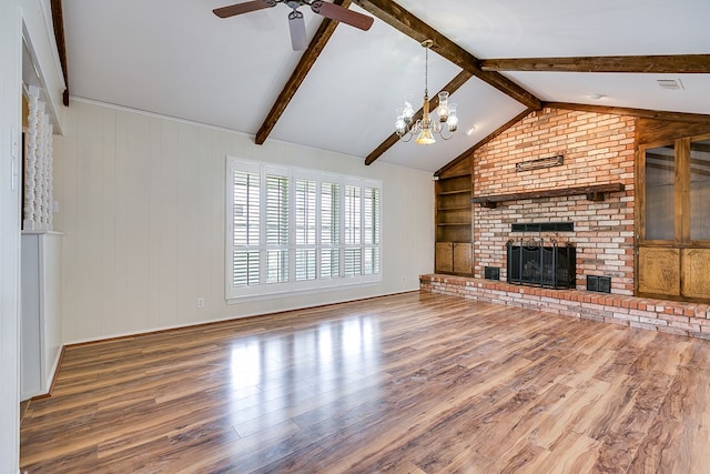 4302 Homestead Cir, Wall, TX 76903 - unfurnished living room with wood finished floors, a chandelier, a ceiling fan, a fireplace, and built in features