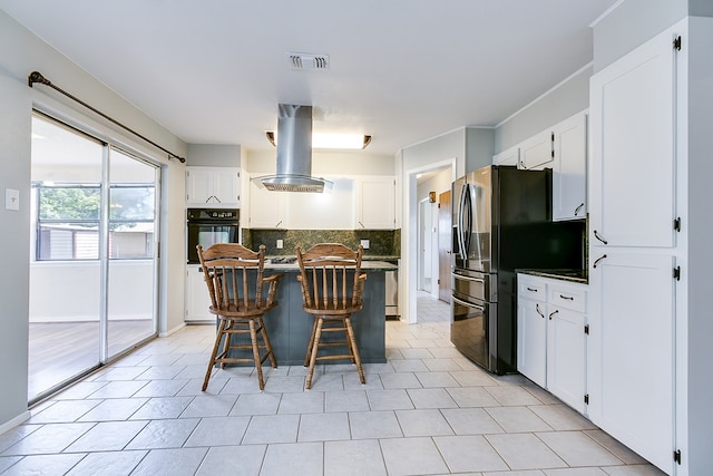 4302 Homestead Cir, Wall, TX 76903 - kitchen featuring oven, freestanding refrigerator, island range hood, backsplash, and a center island