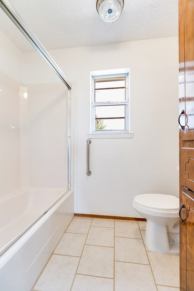 4302 Homestead Cir, Wall, TX 76903 - bathroom with tile patterned floors, toilet, bathing tub / shower combination, a textured ceiling, and baseboards
