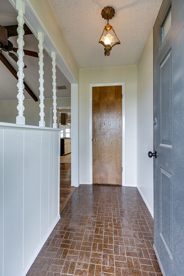 4302 Homestead Cir, Wall, TX 76903 - hall with brick floors and a textured ceiling