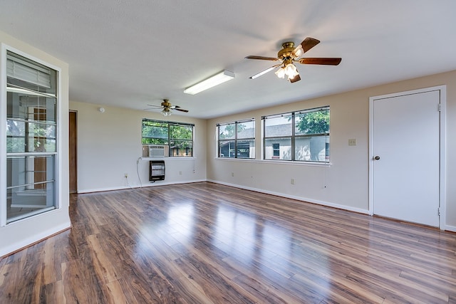 4302 Homestead Cir, Wall, TX 76903 - unfurnished living room featuring ceiling fan, wood finished floors, baseboards, and heating unit