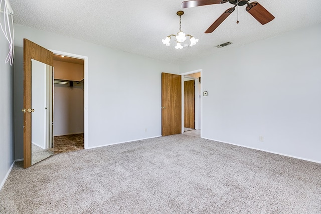 4302 Homestead Cir, Wall, TX 76903 - unfurnished bedroom featuring carpet flooring, a spacious closet, a chandelier, baseboards, and a textured ceiling