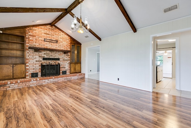 4302 Homestead Cir, Wall, TX 76903 - unfurnished living room with wood finished floors, a chandelier, a fireplace, ceiling fan, and built in shelves