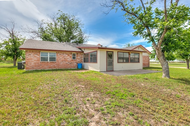 4302 Homestead Cir, Wall, TX 76903 - back of house with a patio area, central air condition unit, a lawn, and brick siding