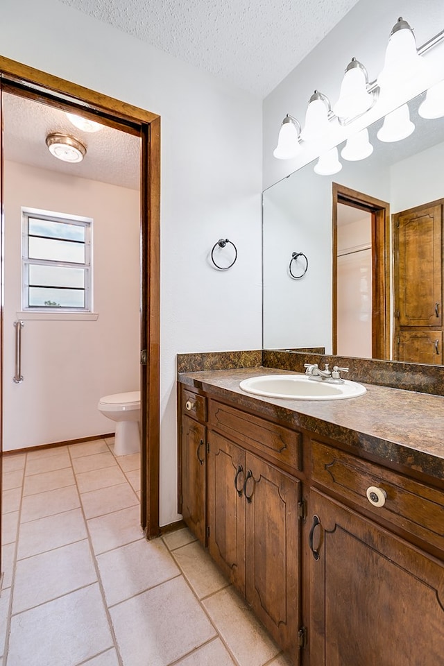 4302 Homestead Cir, Wall, TX 76903 - bathroom featuring a textured ceiling, tile patterned floors, toilet, and vanity