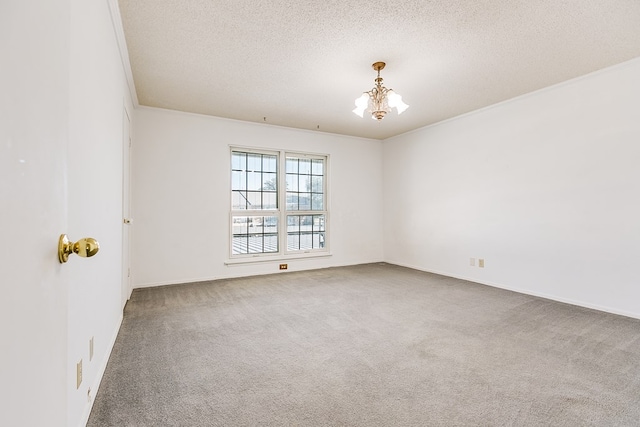 spare room with crown molding, carpet floors, a textured ceiling, and an inviting chandelier