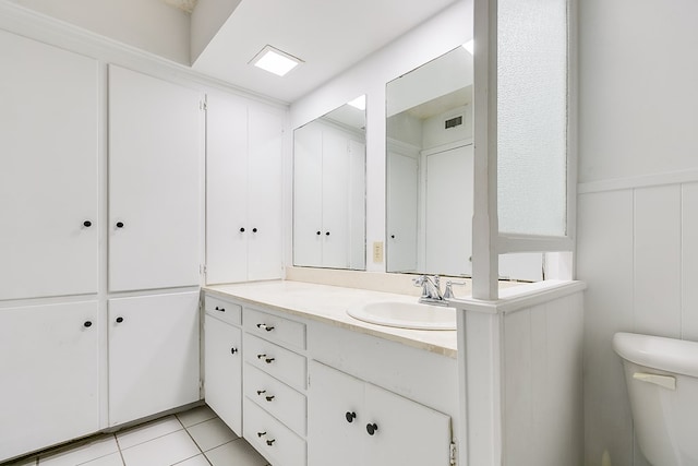 bathroom with tile patterned floors, toilet, and vanity