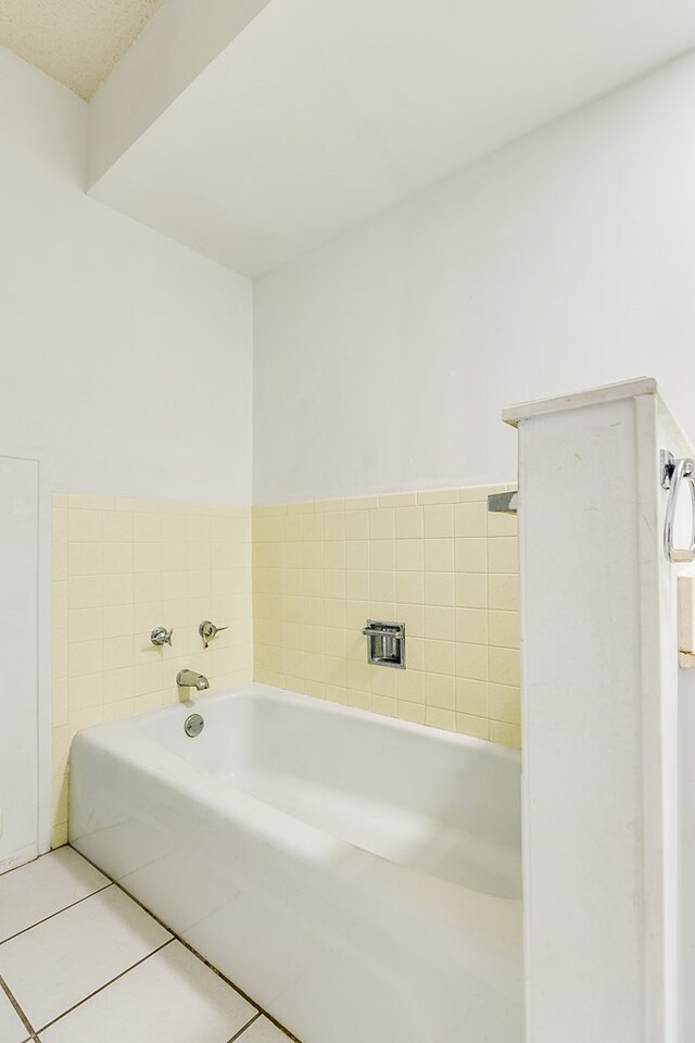 bathroom featuring tile patterned floors and a bathtub