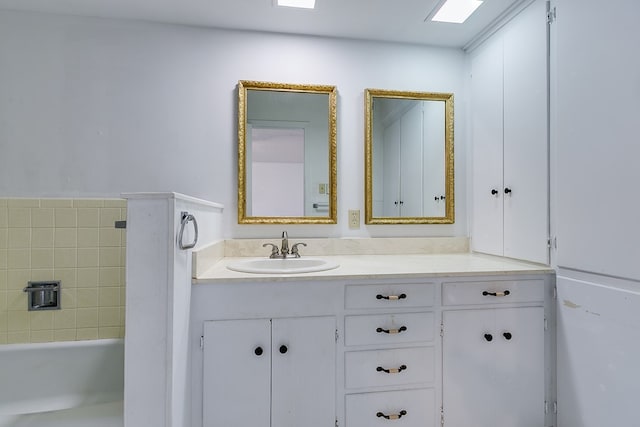 bathroom with vanity and a bath