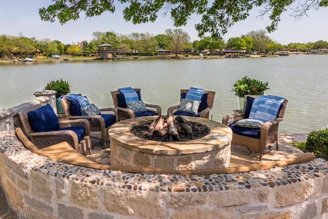 dock area featuring a fire pit and a water view