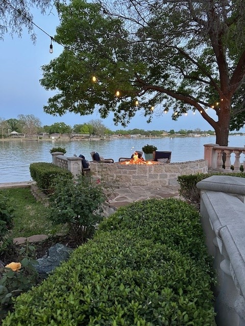 property view of water with a fire pit
