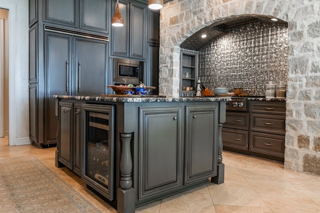 bar featuring beverage cooler, built in appliances, and indoor wet bar