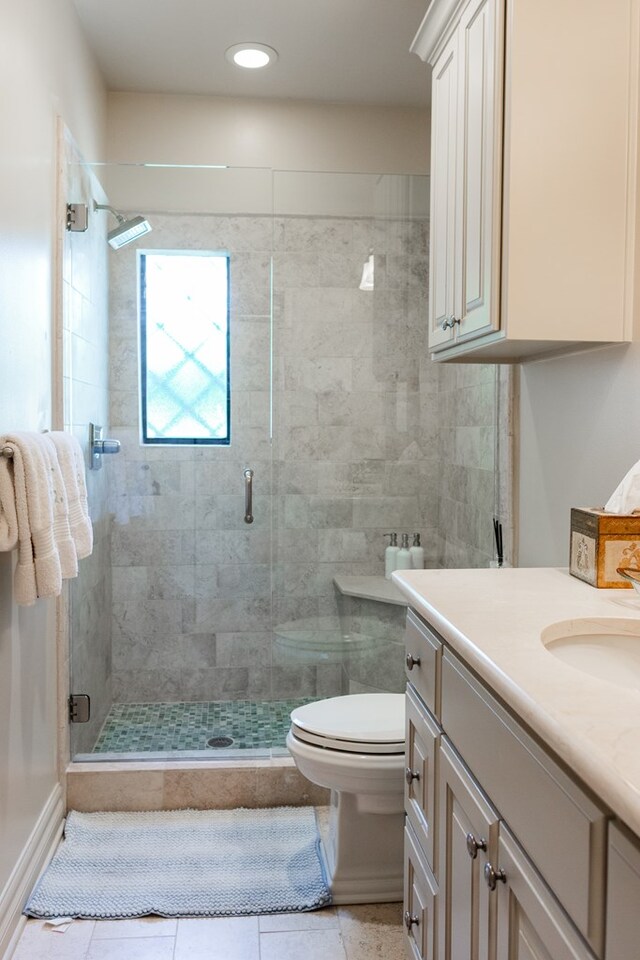 full bath with toilet, a stall shower, recessed lighting, tile patterned flooring, and vanity