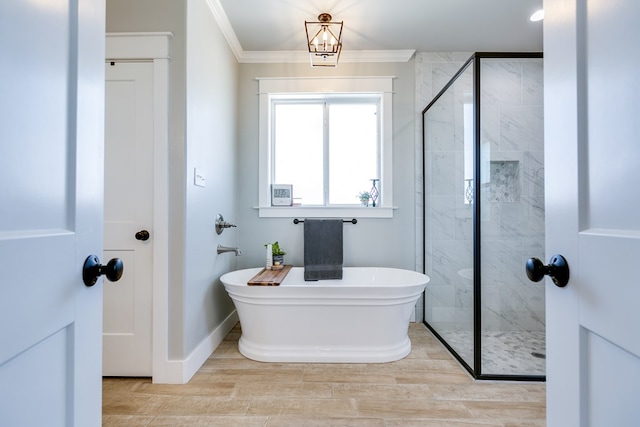 bathroom with a freestanding bath, baseboards, wood finished floors, a shower stall, and crown molding