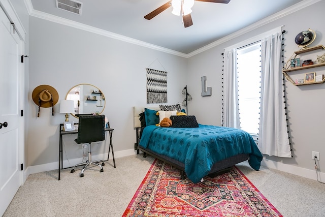 carpeted bedroom with a ceiling fan, baseboards, crown molding, and visible vents
